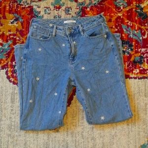 Mom jeans with daisy embroidery.